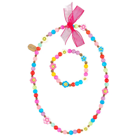 Armband en ketting Carice met kleurrijke kralen, bloemen en smileys, en een roze strik aan de ketting.