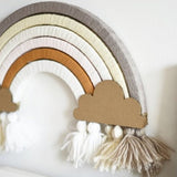 DIY regenboog Nude met bogen in zachte tinten, kartonnen wolken en witte, crème en taupekleurige kwastjes.