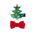 Twee haarclips: een groene glitterkerstboom met gekleurde steentjes en een gouden ster, en een rode glitterstrik.